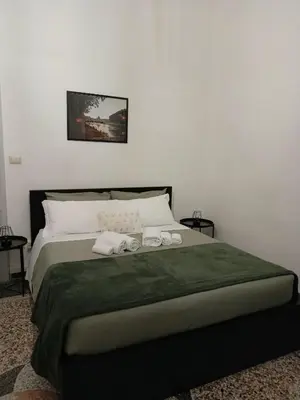 a bedroom with a bed with two towels on it at Rome - Termini House in Rome