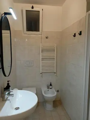 a white bathroom with a sink and a toilet at Rome - Termini House in Rome