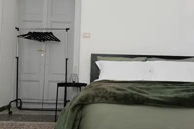 a bedroom with a bed and a closet and a door at Rome - Termini House in Rome