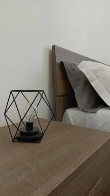 a lamp sitting on a table next to a bed at Rome - Termini House in Rome