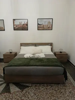 a bedroom with a large bed with two night stands at Rome - Termini House in Rome
