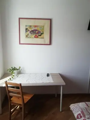 a table with a chair and a picture on a wall at Porta Maggiore GH Locazione Turistica in Rome
