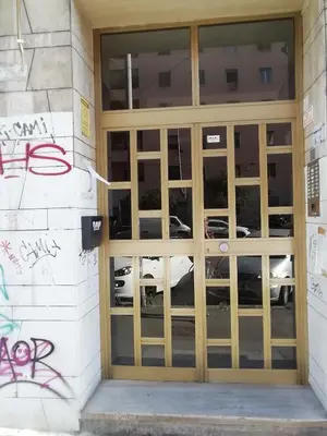 a door to a parking garage with graffiti on the wall at Porta Maggiore GH Locazione Turistica in Rome