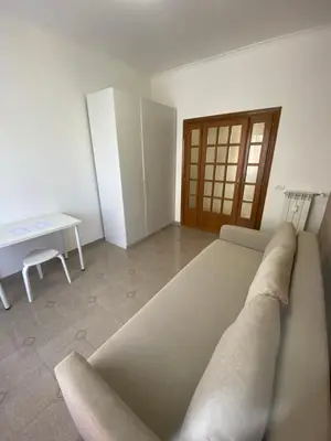 a room with a bed and a table in it at AURA APARTMENT in Rome