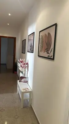 a room with a table and pictures on a wall at AURA APARTMENT in Rome