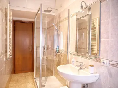 a bathroom with a sink and a shower at AURA APARTMENT in Rome