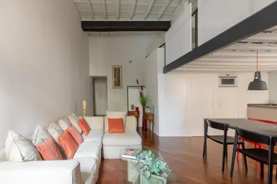 a living room with a white couch and a table at iFlat The Tiber Gem in Rome