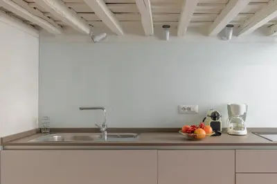 a kitchen with a sink and a bowl of fruit at iFlat The Tiber Gem in Rome