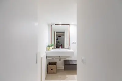 a bathroom with a white sink and a mirror at iFlat The Tiber Gem in Rome