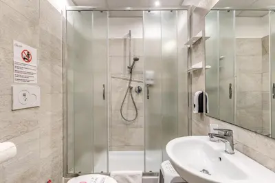 a bathroom with a shower and a toilet and a sink at Gardenia Suite in Rome