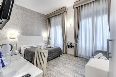 a hotel room with a bed and a desk at Gardenia Suite in Rome