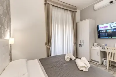 a bedroom with a bed with towels on it at Gardenia Suite in Rome