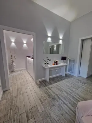 a room with a white desk and a mirror at Gardenia Suite in Rome