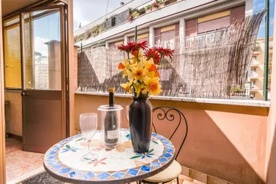 a table with a vase of flowers on a balcony at Vatican Penthouse Near S.Peter's Square in Rome
