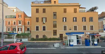 a red car parked in front of a building at Vatican Penthouse Near S.Peter's Square in Rome