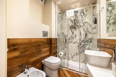 a bathroom with a toilet and a sink and a shower at alloggio la carica dei 101 in Rome