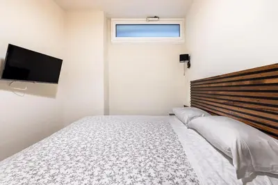 a bedroom with a bed and a flat screen tv at alloggio la carica dei 101 in Rome