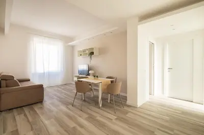 a living room with a table with chairs and a computer at Sweet Rhome to Colosseum in Rome