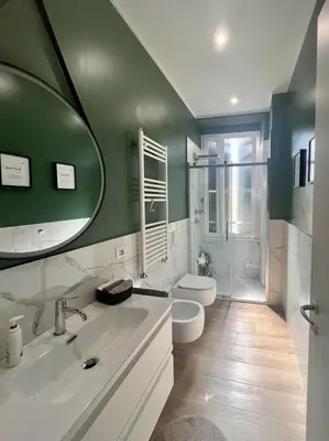 a bathroom with a sink and a toilet and a mirror at Cioccis Boutique Apartment in Rome