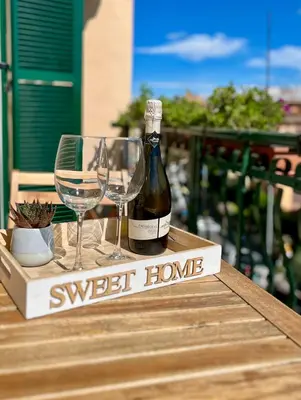 a bottle of wine and two glasses on a table at Cioccis Boutique Apartment in Rome
