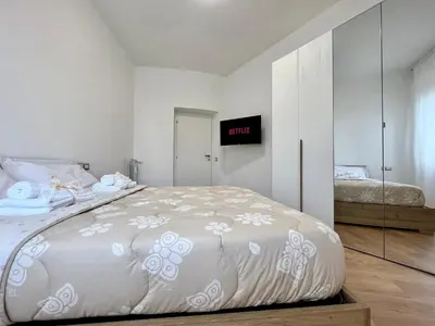 a bedroom with a large bed and a mirror at PyramidHouse Rome - Apartment 100mq with View - 2km from the Colosseum in Rome