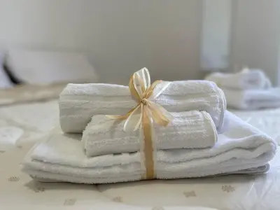 a pile of towels with a bow on top of them at PyramidHouse Rome - Apartment 100mq with View - 2km from the Colosseum in Rome
