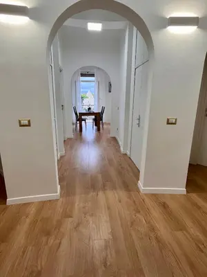 an open hallway with a dining room and a table at PyramidHouse Rome - Apartment 100mq with View - 2km from the Colosseum in Rome