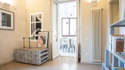 a hallway with a door open to a dining room at EasyTopStay - Trastevere Cozy Nest with Terrace in Rome