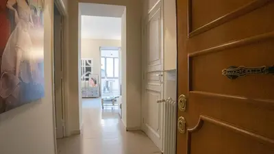 a hallway with a door and a room with a violin at EasyTopStay - Trastevere Cozy Nest with Terrace in Rome