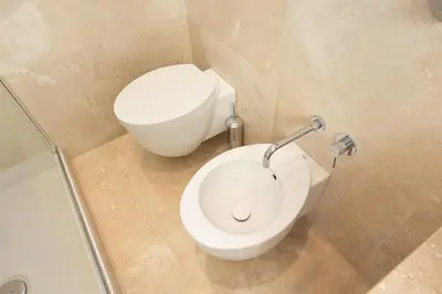 a bathroom with a white toilet and a sink at Amazing Cozy Piazza Venezia in Rome