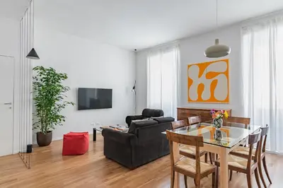 a living room with a table and a couch at GIULIANA Boutique Apartment in Rome