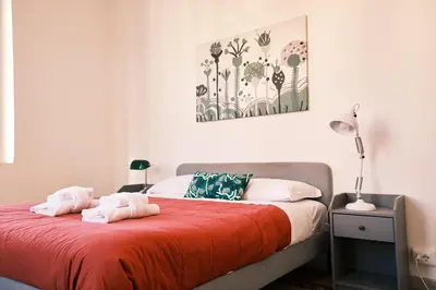 a bedroom with a bed with two towels on it at Carolina Trastevere House in Rome