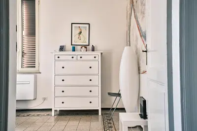 a bedroom with a chest of drawers and a mirror at Carolina Trastevere House in Rome