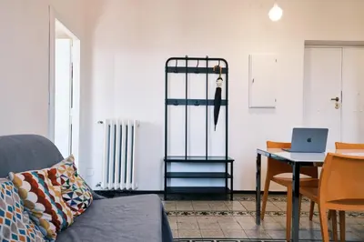 a living room with a couch and a table with a laptop at Carolina Trastevere House in Rome
