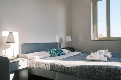 a bedroom with a bed with towels on it at Carolina Trastevere House in Rome