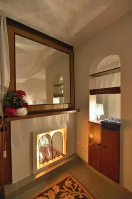 a fireplace in a living room with a mirror at Colosseum Colosseo in Rome