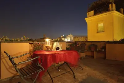 a table with a candle on a balcony at night at Colosseum Colosseo in Rome