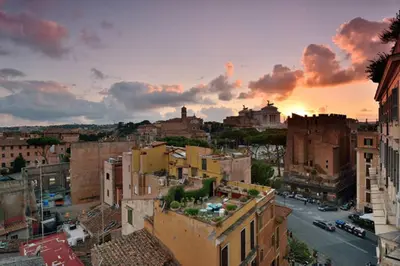 a view of a city at sunset with buildings at Colosseum Colosseo in Rome