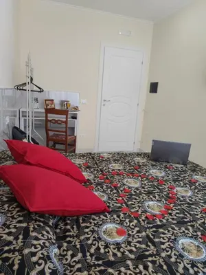 a room with a bed with red pillows on it at NINFA in Rome