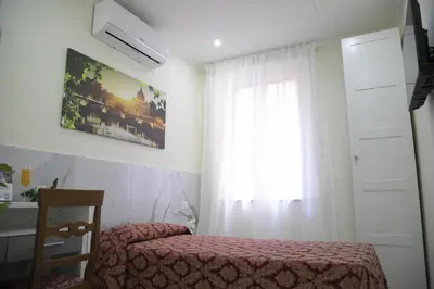 a bedroom with a bed and a window at NINFA in Rome