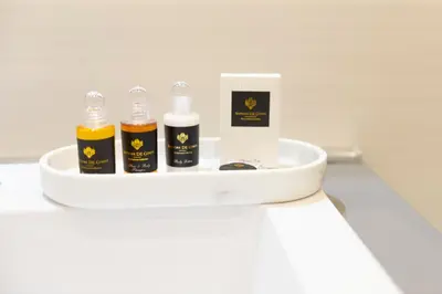 four bottles of essential oils on a white shelf at Élite Vatican Refuge in Rome
