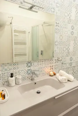 a bathroom with a sink and a mirror at Élite Vatican Refuge in Rome