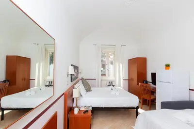 a bedroom with a white bed and a window at Rental in Rome 2012 Guest House - ZEN16 in Rome
