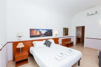 a bedroom with a large white bed and a couch at Rental in Rome 2012 Guest House - ZEN16 in Rome