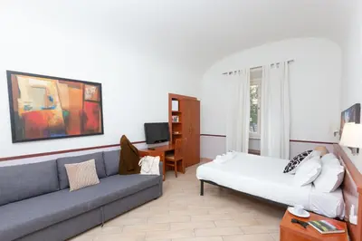 a bedroom with a bed and a picture on the wall at Rental in Rome 2012 Guest House - ZEN16 in Rome