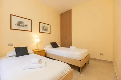 a room with two beds and a lamp at Trastevere Garden by Rental in Rome in Rome