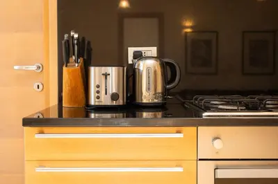a kitchen with a counter top with a kettle and a stove at Trastevere Garden by Rental in Rome in Rome