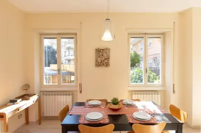 a kitchen and dining room with a table and chairs at Trastevere Garden by Rental in Rome in Rome