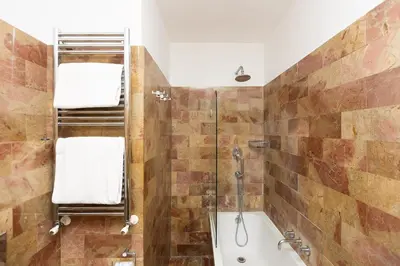a bathroom with a shower and a bath tub at Trastevere Garden by Rental in Rome in Rome