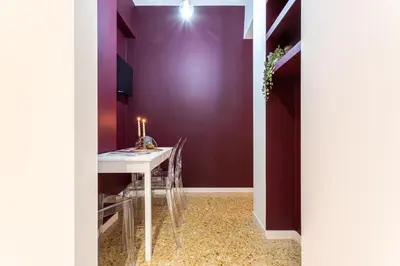 a dining room with a table and a purple wall at YCH-Cozy Flat at the Vatican in Rome